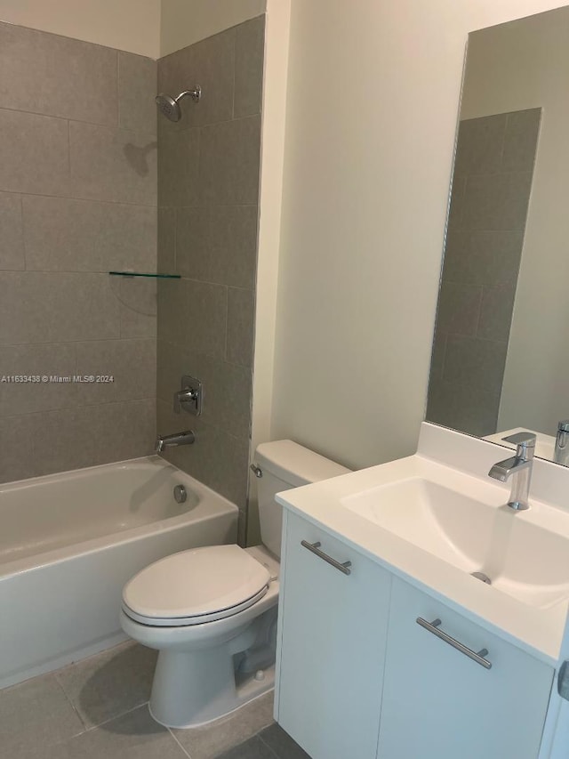 full bathroom with vanity, tiled shower / bath, tile patterned flooring, and toilet