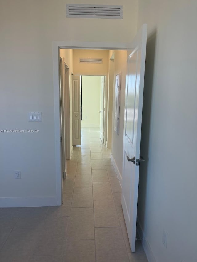 hallway with tile patterned floors