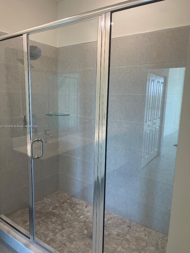 bathroom with a shower with shower door