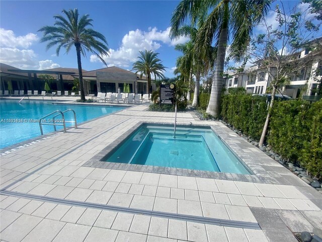 view of pool featuring a hot tub