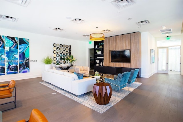 living room featuring french doors and dark wood-type flooring