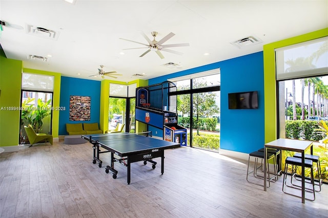 rec room featuring ceiling fan, light hardwood / wood-style flooring, and plenty of natural light