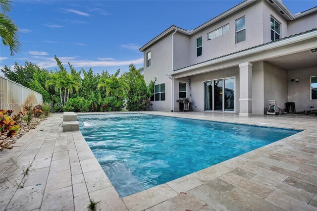 view of swimming pool with a patio and pool water feature