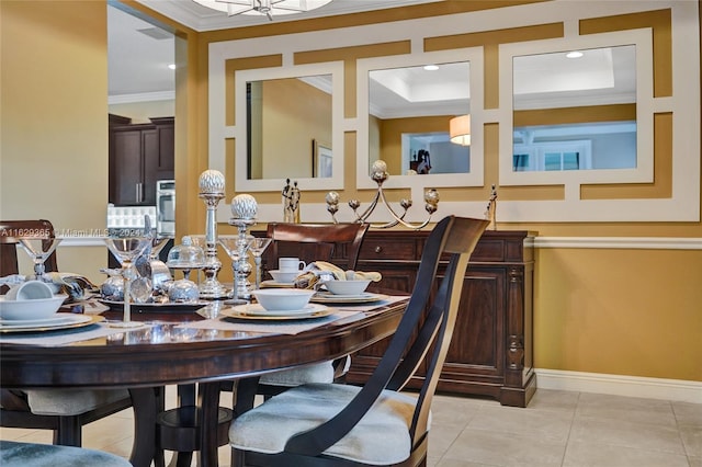 tiled dining room featuring crown molding