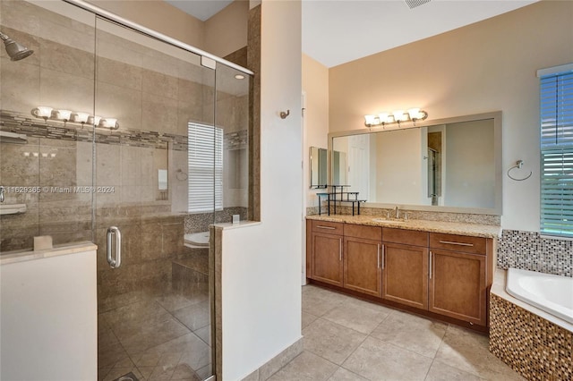 bathroom featuring tile patterned flooring, vanity, and independent shower and bath