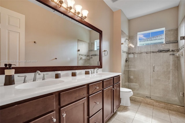 bathroom featuring double vanity, toilet, tile patterned floors, and a shower with shower door