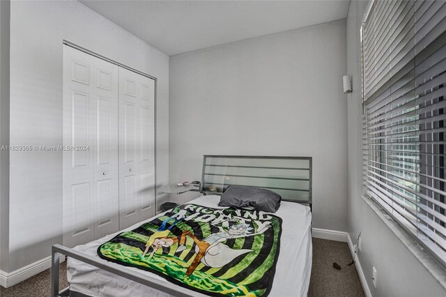 carpeted bedroom with a closet