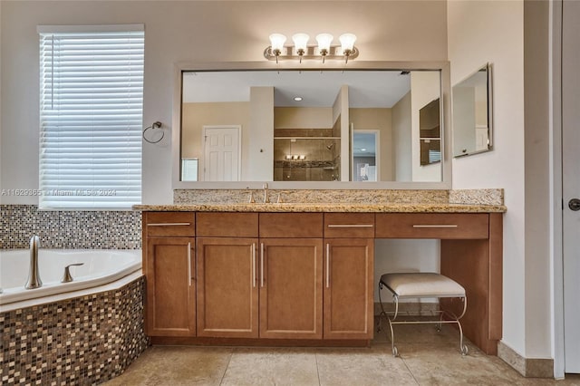 bathroom with vanity, a relaxing tiled tub, and tile patterned flooring