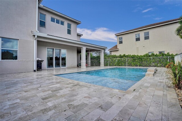 view of swimming pool featuring a patio area and area for grilling