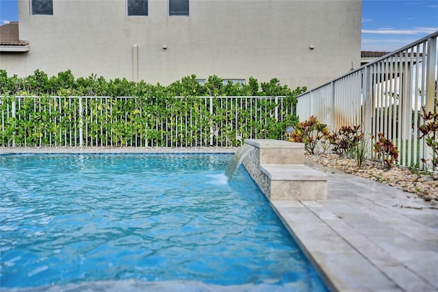 view of pool with pool water feature