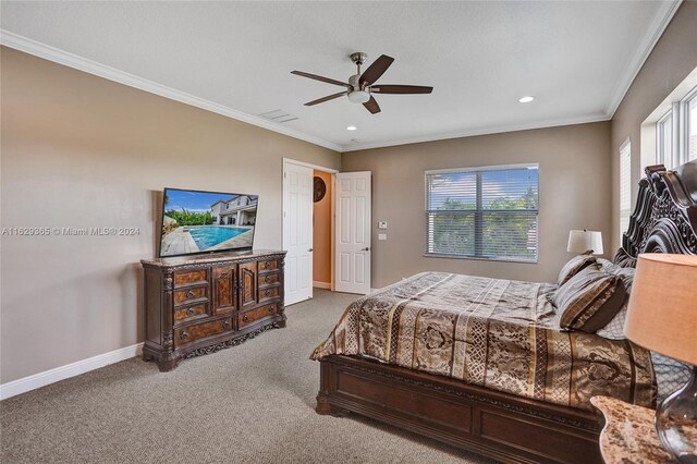 bedroom with ceiling fan, carpet flooring, and crown molding