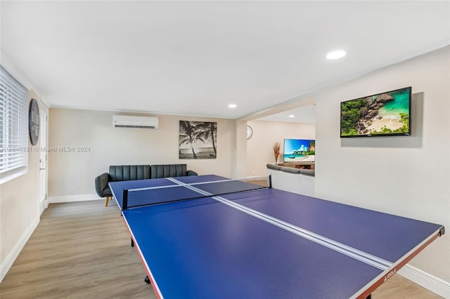 5740 NE 19th Ave, Fort Lauderdale, FL 33308 - recreation room featuring light wood-style floors, baseboards, a wall mounted air conditioner, and recessed lighting