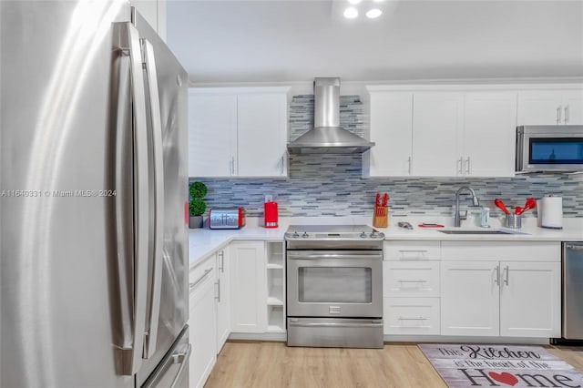 5740 NE 19th Ave, Fort Lauderdale, FL 33308 - kitchen featuring light countertops, a sink, stainless steel appliances, and wall chimney exhaust hood