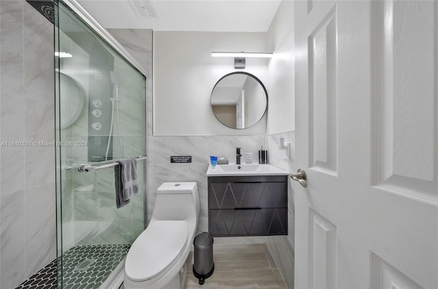 5740 NE 19th Ave, Fort Lauderdale, FL 33308 - bathroom with tile walls, toilet, a stall shower, and vanity