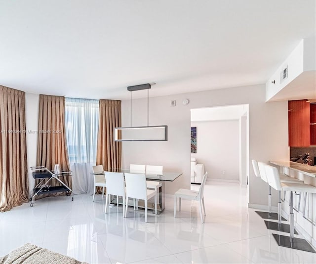 unfurnished dining area with light tile patterned floors