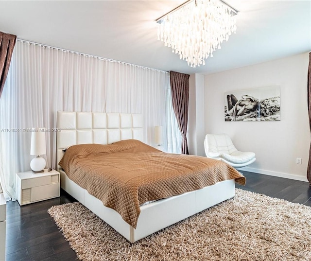 bedroom featuring dark wood-type flooring and a chandelier