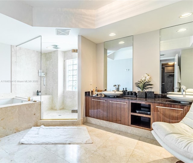 bathroom featuring vanity and separate shower and tub