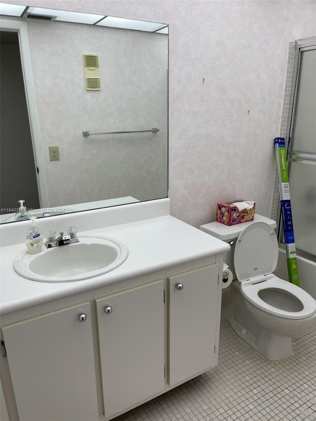 bathroom with tile patterned floors, vanity, and toilet