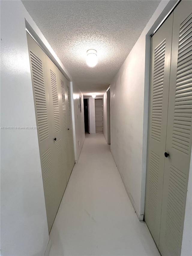 hallway featuring a textured ceiling