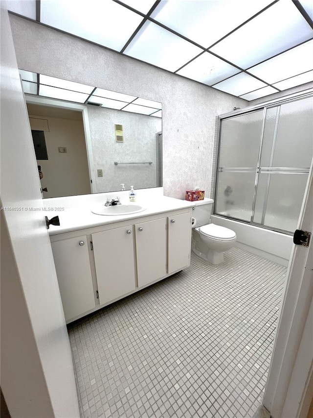 full bathroom with vanity, toilet, tile patterned flooring, and combined bath / shower with glass door
