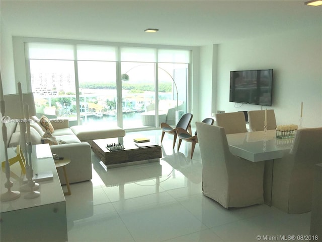 living room with expansive windows and tile patterned flooring