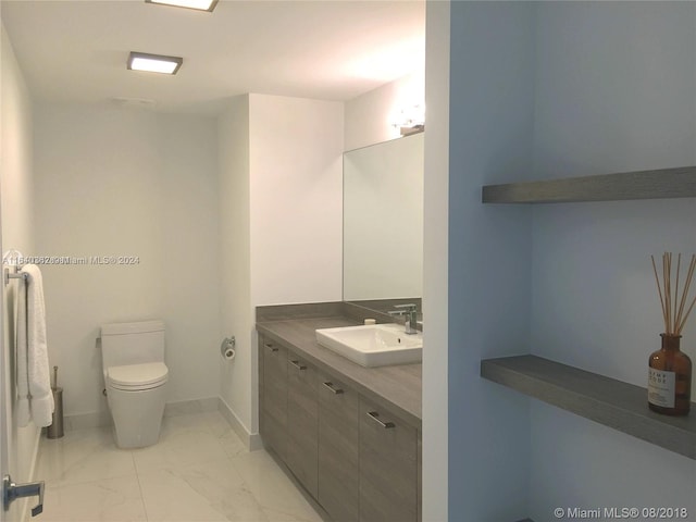 bathroom featuring tile patterned floors, vanity, and toilet