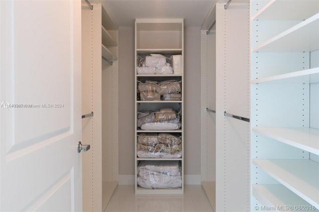 walk in closet featuring tile patterned flooring