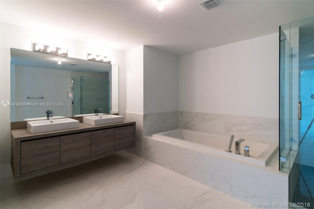 bathroom with double vanity, plus walk in shower, and tile patterned flooring