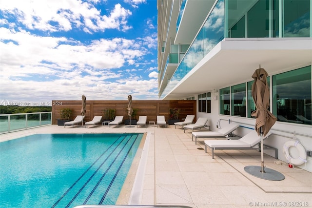 view of swimming pool with a patio area