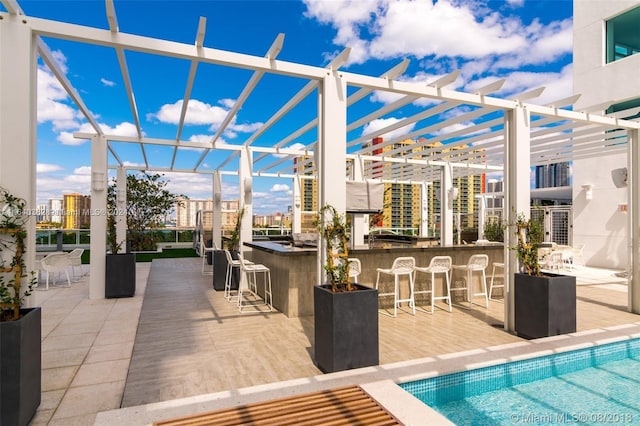 view of patio with a pergola and a bar