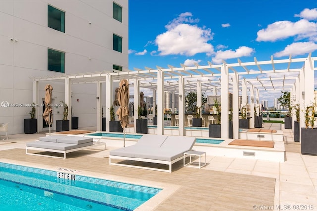 view of swimming pool featuring a pergola