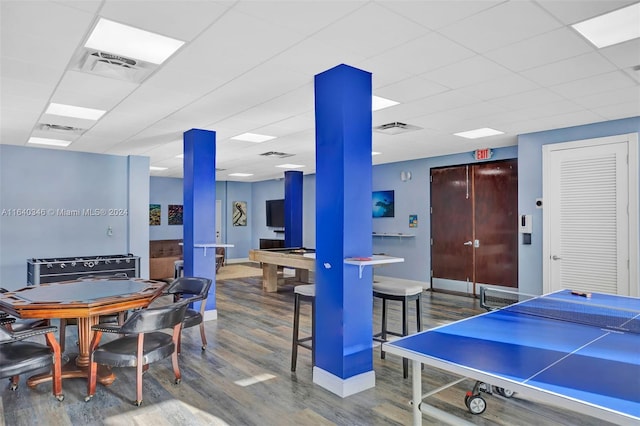 rec room featuring a paneled ceiling, wood-type flooring, and billiards