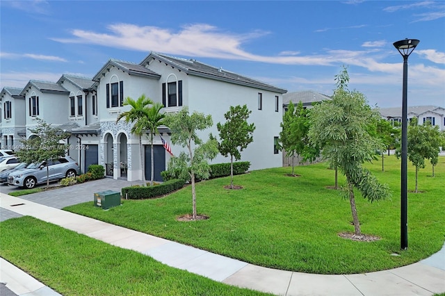 view of front of property with a front lawn and a garage