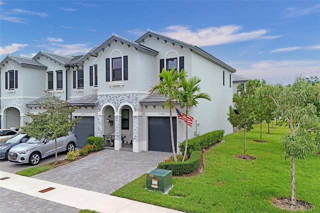 view of front facade with a garage and a front lawn