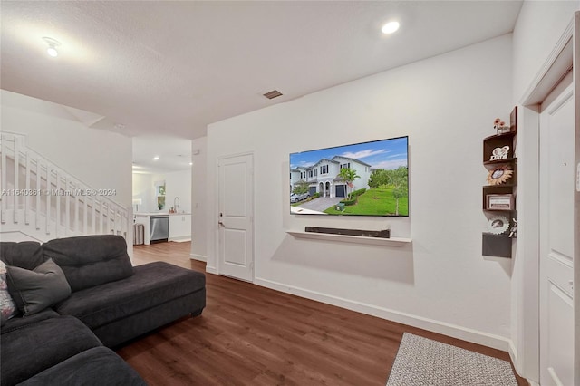 living room featuring dark hardwood / wood-style flooring and sink