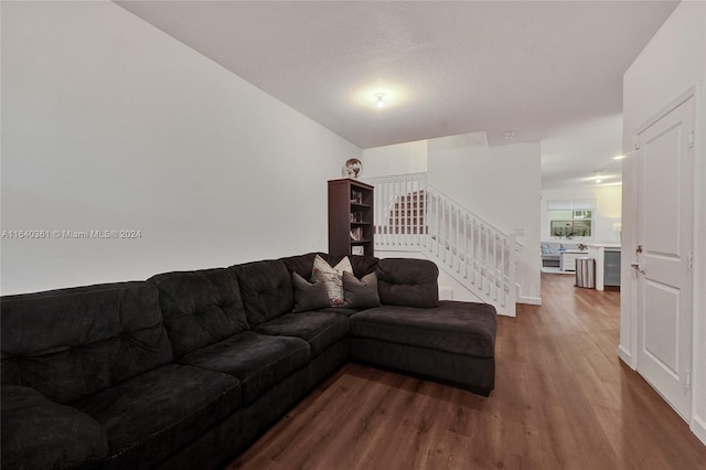 living room featuring hardwood / wood-style floors and a textured ceiling