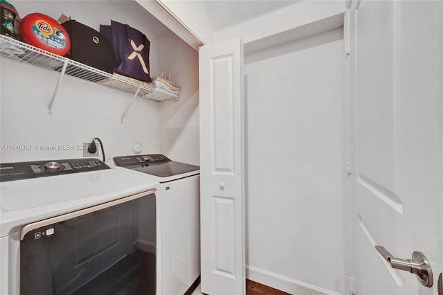 laundry area with hardwood / wood-style floors and washing machine and dryer