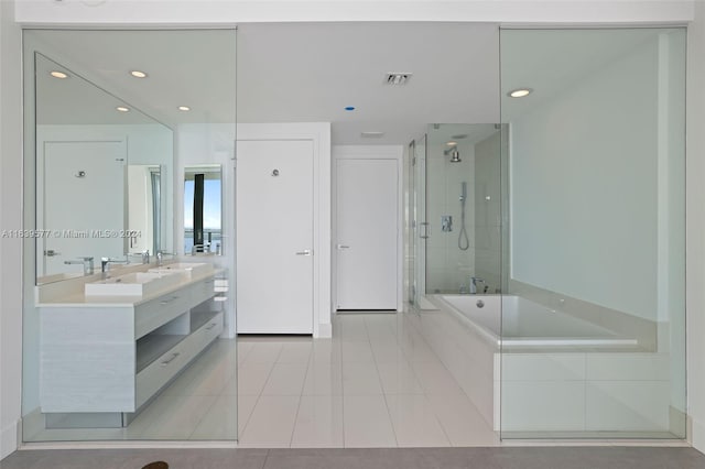 bathroom featuring dual vanity, separate shower and tub, and tile patterned flooring