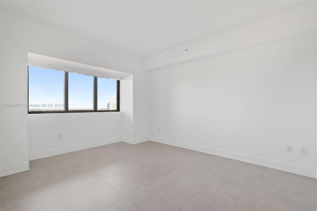 spare room featuring light tile patterned floors