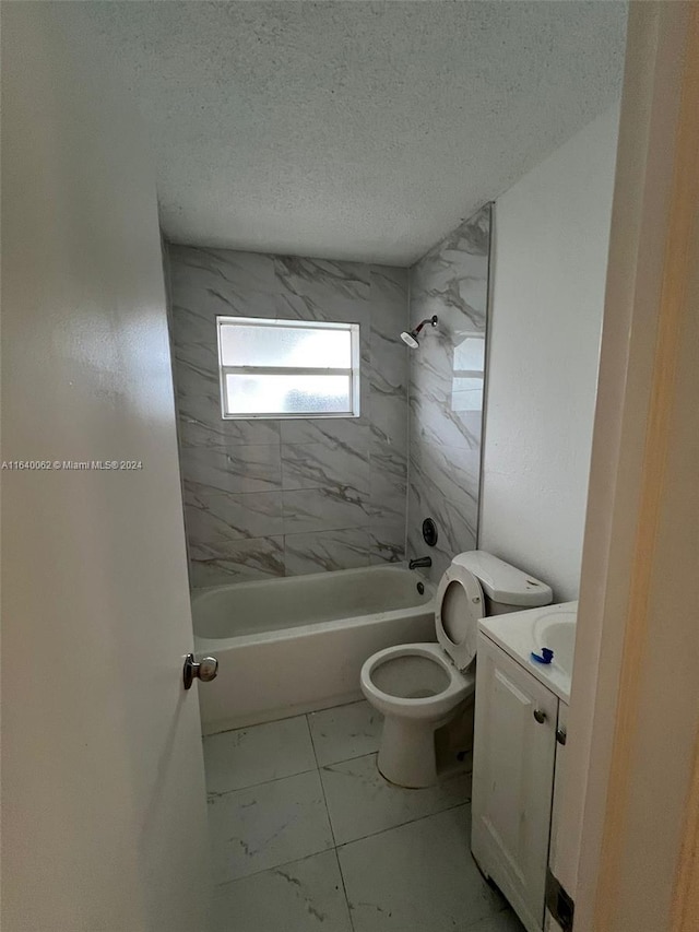 bathroom with vanity, toilet, marble finish floor, a textured ceiling, and shower / washtub combination
