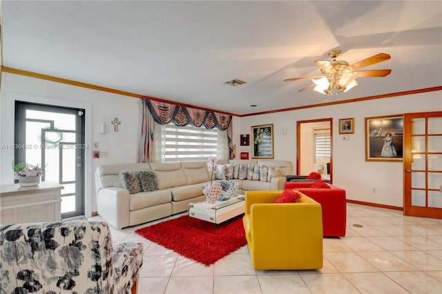 living room with a wealth of natural light, light tile patterned flooring, and ceiling fan