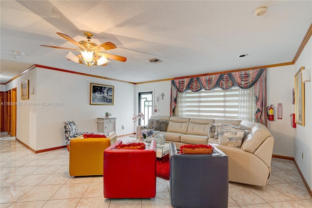 tiled living room featuring ceiling fan, ornamental molding, and a textured ceiling