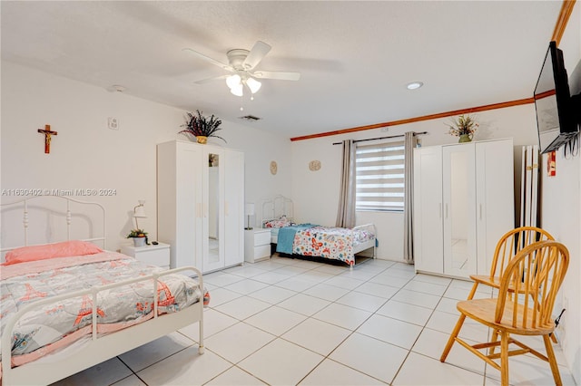 tiled bedroom featuring ceiling fan