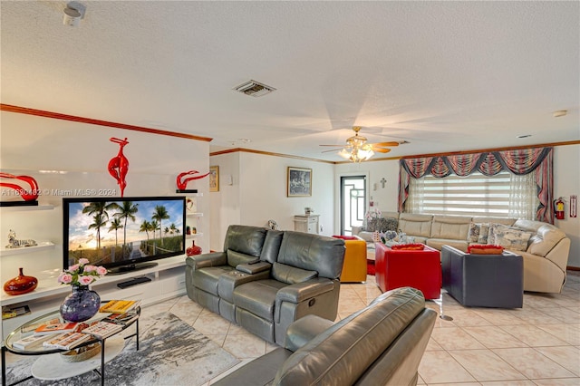 living room featuring ceiling fan, light tile patterned floors, crown molding, and a textured ceiling