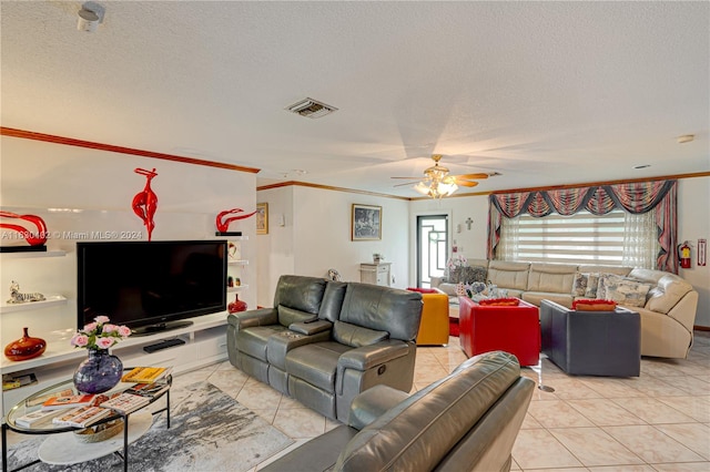 tiled living room featuring ceiling fan, ornamental molding, and a textured ceiling