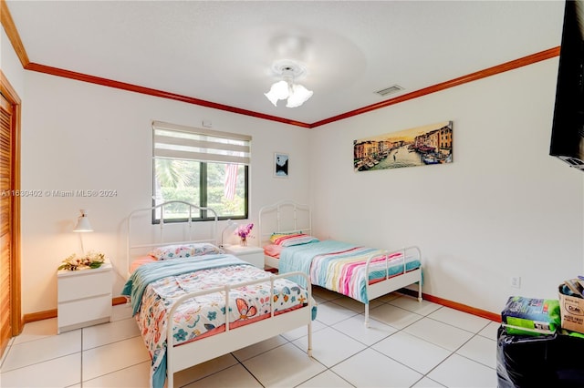 bedroom featuring ceiling fan, light tile patterned flooring, and ornamental molding