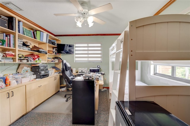 carpeted home office with ceiling fan and ornamental molding