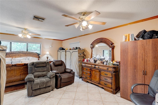 bedroom with ceiling fan, light tile patterned floors, and a textured ceiling