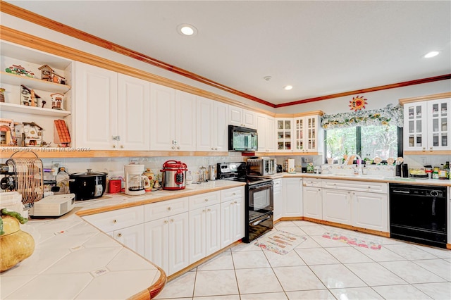 kitchen featuring crown molding, backsplash, black appliances, sink, and white cabinets