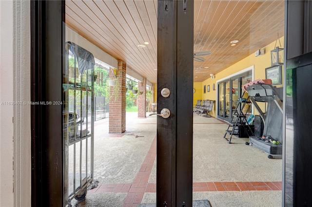 entryway featuring carpet and wooden ceiling